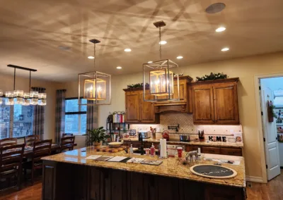 A kitchen with wooden cabinets and a large island.