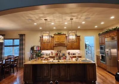 A kitchen with wooden floors and a large island.